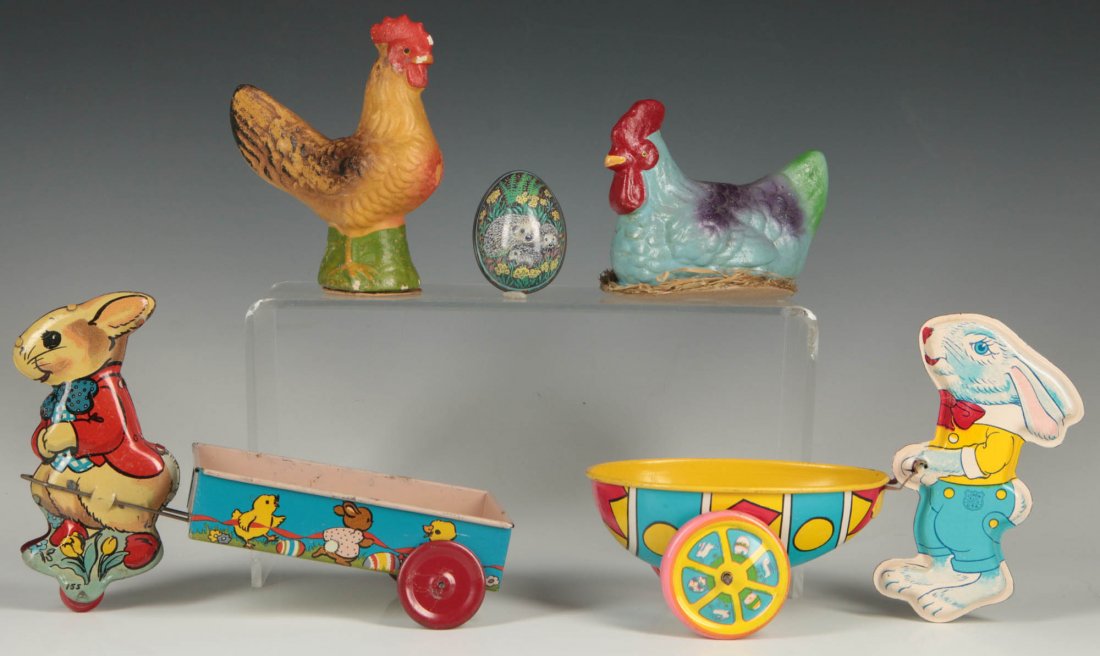 A COLLECTION OF EASTER HOLIDAY TIN LITHO AND PAPIER: The collection includes two figural chicken papier mache candy containers ink stamped Germany, along with tin litho wheeled toys by Ohio Art and others, and an egg-shape container, all circa mid 20th 