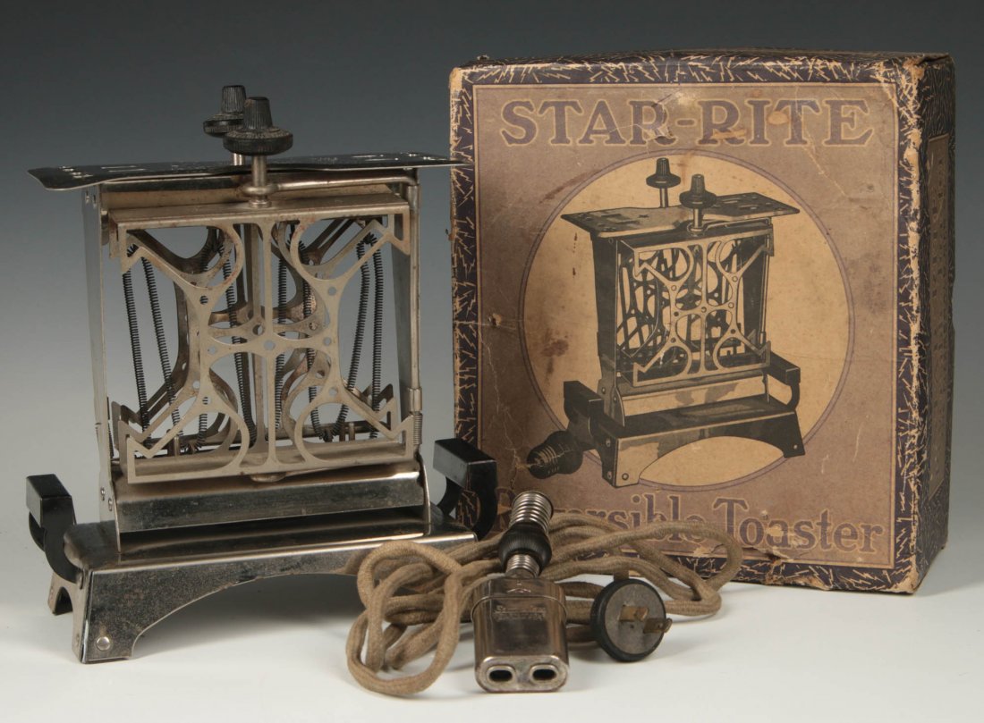 A 1920s FITZGERALD STAR-RITE REVERSIBLE TOASTER IN BOX: The action with two swing-out arms and swivel carriers to flip the toast around and brown the other side; signed on the Bakelite knobs and under the base. The toaster measures 9 x 8 x 3.75 inches, box