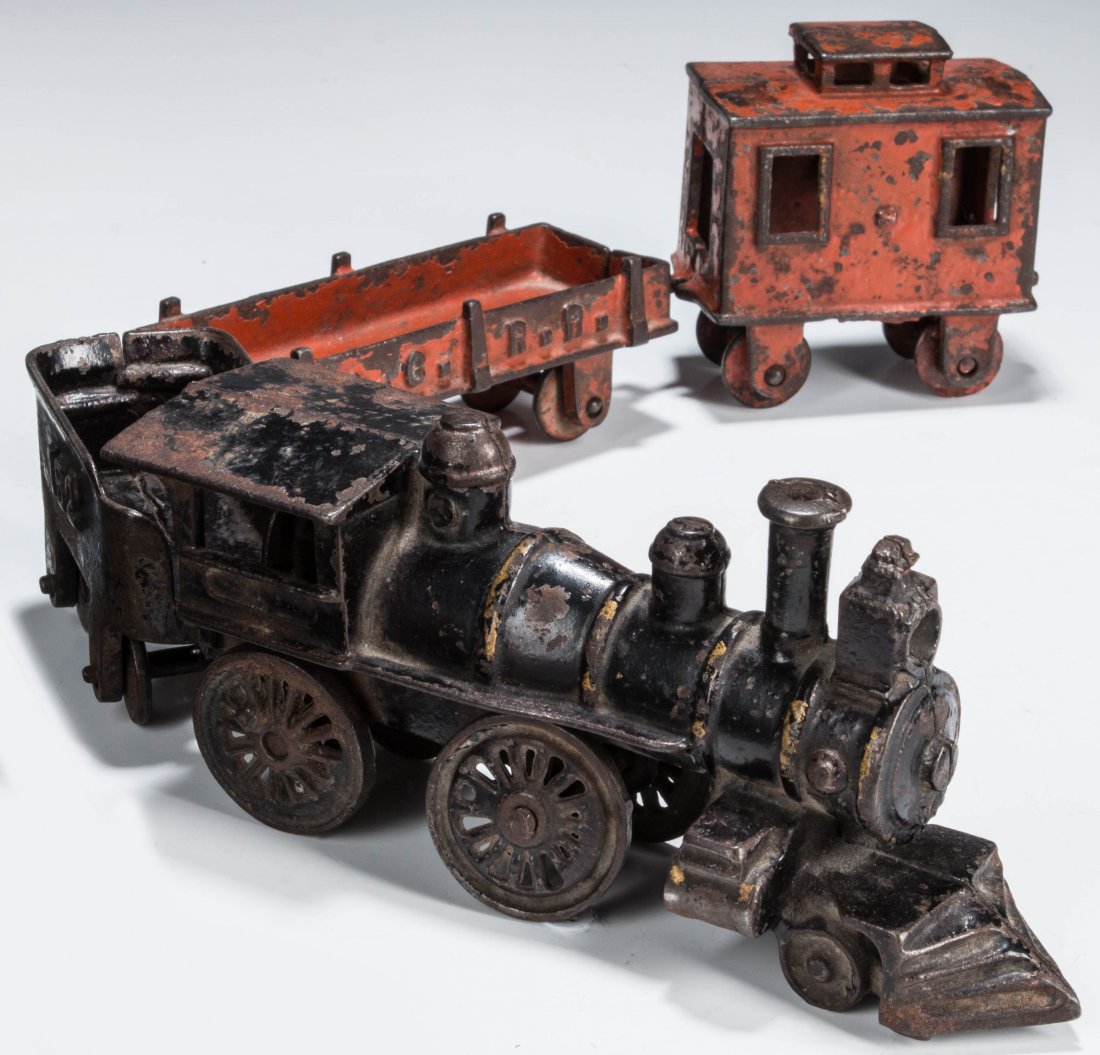 DENT HARDWARE CAST IRON FLOOR TRAIN CIRCA 1895: Four piece train with a locomotive and 152 tender, gondola and a caboose, locomotive measures 3.25 x 7 inches, tender 2 x 4 inches, gondola 1.75 x 6, and the caboose 3.5 x 3.5, train length 19.5 inche