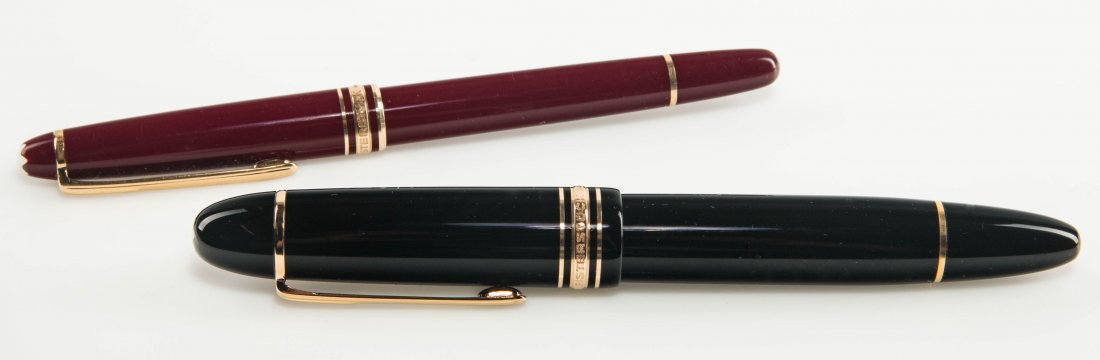 TWO MODERN MONTBLANC MEISTERSTUCK FOUNTAIN PENS: A black Montblanc Meisterstück 149 fountain pen with 14k nib and a red Montblanc ball point pen. The sizes range from 5.5 to 5.75 inches. We ship in-house for all items with the exception of very lar