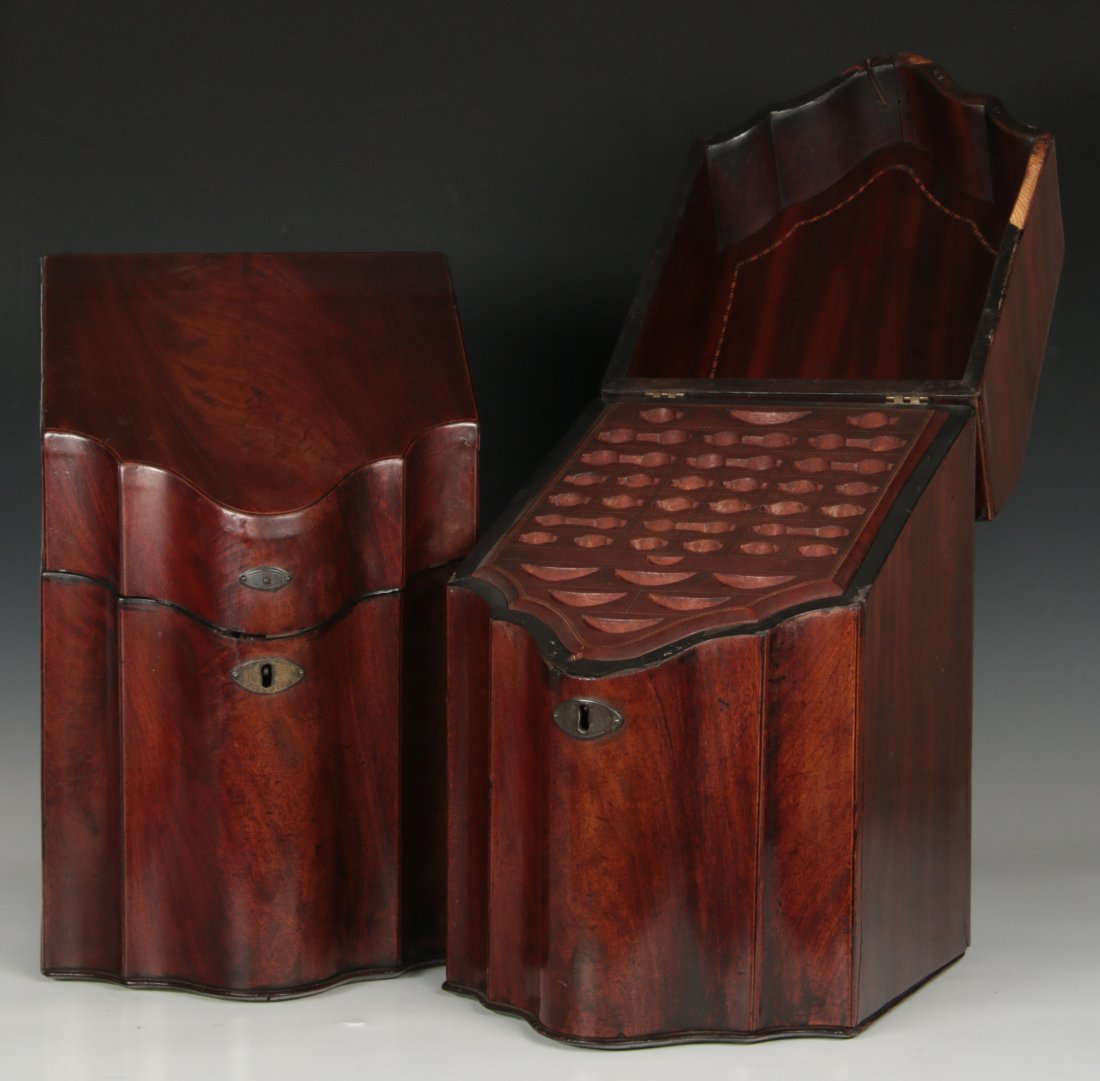 A PAIR HEPPLEWHITE MAHOGANY KNIFE AND CUTLERY BOXES: A pair of circa 1800 knife and cutlery boxes with double serpentine hinged slant tops on conforming box set with an inlaid and 1237d slant mahogany interior tray. Each measure 15 x 11 x 9 inches each.