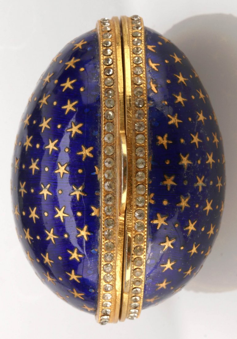 TWO LATE 20TH C. GILT STERLING SILVER CHAMPLEVÉ EGGS: Two champlevé enameled silver eggs measuring 2 and 2.5 inches, one marked Sterling. Plus a cobalt blue enameled egg with gilt interior and stars trimmed in brilliants, measures 2 inches. We ship in-h
