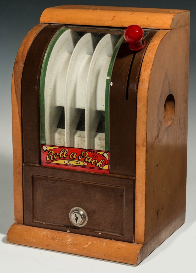C. 1940 VICTOR 'ROLL A PACK' DICE TRADE STIMULATOR: A circa 1940s dice game trade stimulator with decal on glass and maple wood case. Pulling the spring action handle pops the dice and three of a kind wins. Measures 12 x 7.5 x 7 inches. We ship in-hous