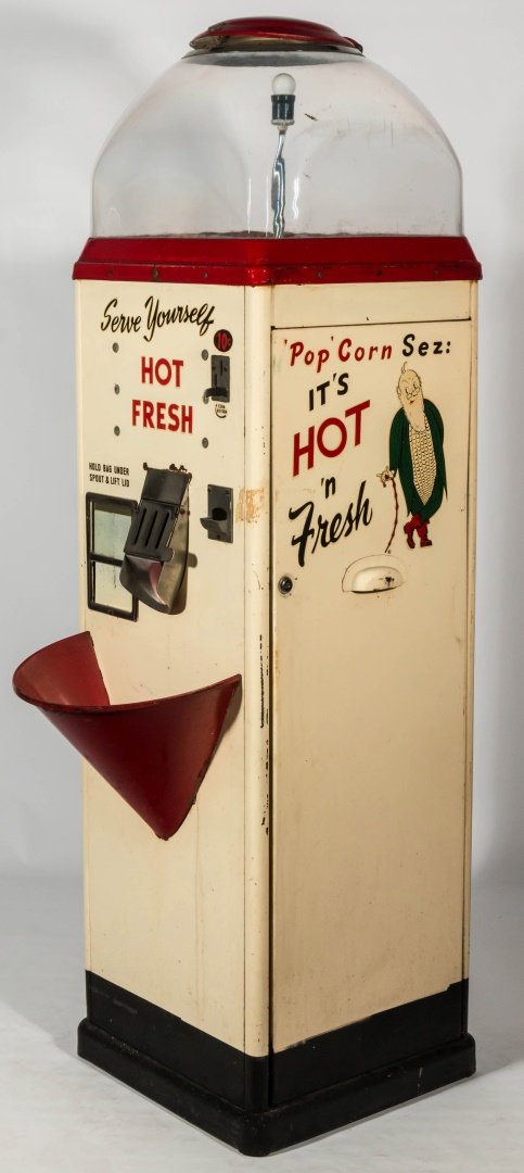 VINTAGE 'POP'CORN 10 CENT POPCORN VENDING MACHINE: A floor model popcorn vending machine, "'Pop' Corn says It's HOT n' Fresh", 'Serve Yourself' 10 cent coin slot, 'Hold Bag Under Spout and Lift Lid' White with black, red and green graphics. Measures 6