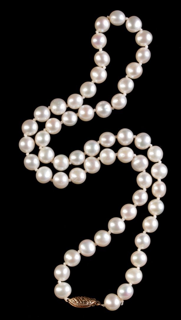 A CHOKER LENGTH PEARL STRAND WITH 14K GOLD CLASP: Pearls measure 7 mm each, necklace length 18 inches. We ship in-house for all items with the exception of very large and or very fragile pieces and some international shipments. This lot is subject to