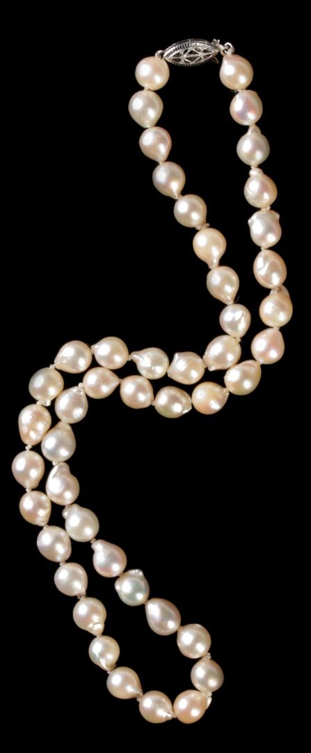 A CHOKER LENGTH STRAND OF BAROQUE PEARLS: With a 10k white gold clasp, pearls measure 7 mm, necklace length 16 inches. We ship in-house for all items with the exception of very large and or very fragile pieces and some international shipments