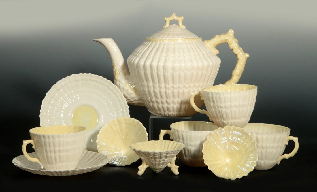COLLECTION OF BELLEEK 'LIMPET' PATTERN PORCELAIN: Including a green mark teapot that measures 6.5 x 10 inches, saucers 5.5 inches, cups 2.25 x 4 inches, and small tripod cups 1.5 x 3.25 inches. All green mark items. We ship in-house for all items wit