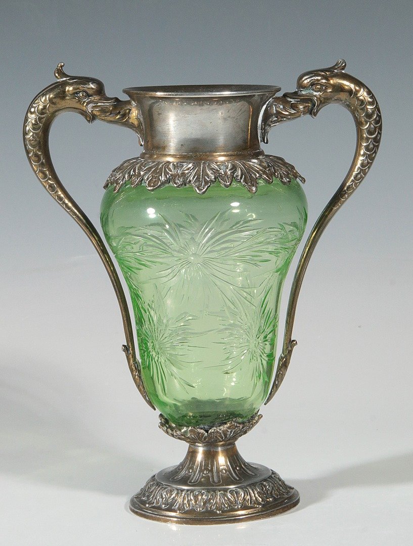 A MOUNTED CUT GREEN GLASS VASE SIGNED PAIRPOINT: A Pairpoint silver-plate mounted green cut glass vase, acanthus leaf decorated circular foot supporting pear-form cut and etched glass vessel with silvered wide plain flaring neck flanked by dolphin h