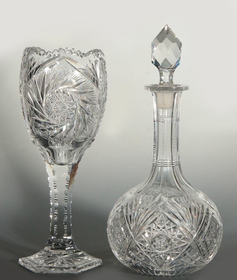 BRILLIANT PERIOD CUT GLASS CHALICE AND DECANTER: The chalice with hexagonal starburst cut foot supporting paneled and notched stem, elongated bowl with buzzcuts and fans terminating in scalloped serrated rim. Plus a decanter of globular shaped bottl