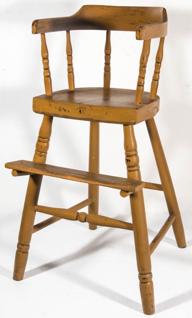 A 19TH CENTURY COUNTRY PRIMITIVE YOUTH CHAIR: The one-piece curved back and arm rests on turned spindles, plank seat raised on turned legs with a front foot rest. Later ocher paint. Measures 28 x 14 x 14 inches. We ship in-house for all items wit