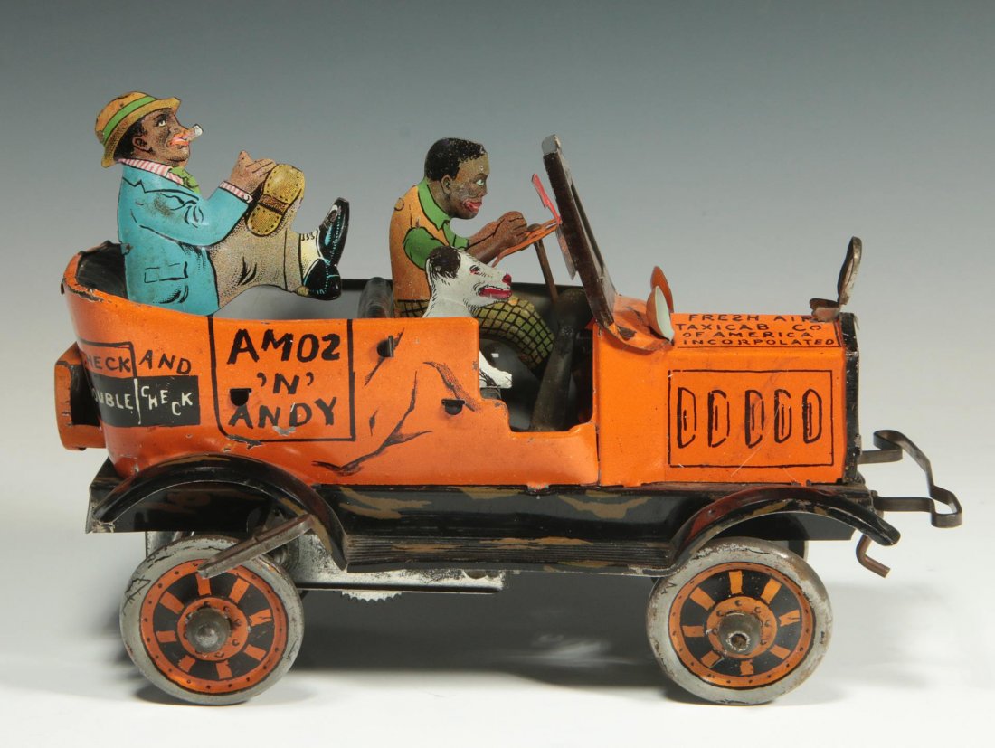 AMOS N ANDY TIN LITHO WIND-UP TOY: Measures 5.25 x 7.5 x 3.5 inches. Includes winding key, and mechanism works. Includes driver, dog and backseat rider in 90% original finish.