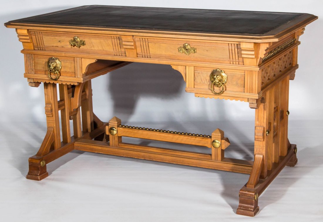 A HANDSOME EASTLAKE INFLUENCE PARTNER'S DESK: A classic Victorian Eastlake influence partner's desk with leather top, burl drawer fronts and lion head pulls. Measures 28 x 48 x 30 inches.