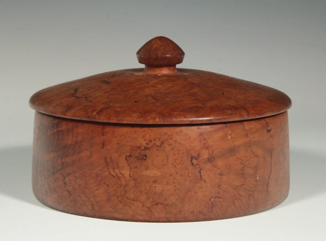A BIRD'S EYE MAPLE CIRCULAR COVERED BOX: Early 20th century. Measures 3.5 x 5.5 inches.