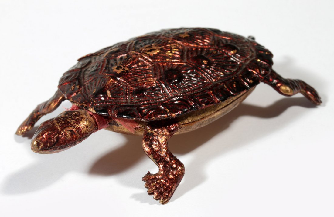 CIRCA 1900 DRESDEN PAPER TURTLE CANDY CONTAINER: Three-dimensional embossed and pieced paper turtle candy container with hand-painted details, measures 1 x 3.5 x 2 inches.