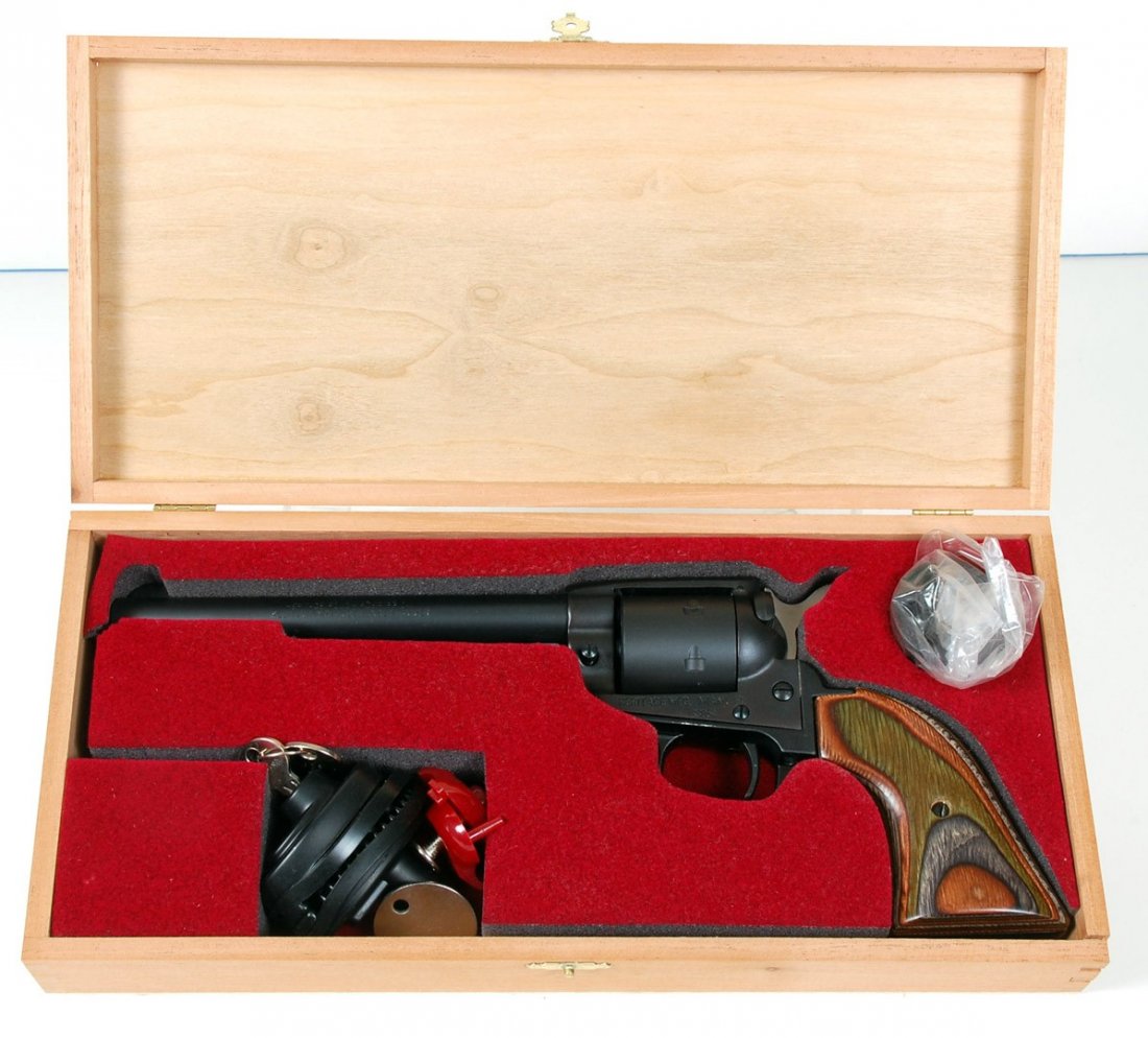 HERITAGE ROUGH RIDER .22 LR & .22 MAG REVOLVER: The Heritage Rough Rider combo with 22 LR cylinder and 22 Mag cylinder, wood grips, trigger lock with key in wood case. Serial number 3354. All handguns will be taken to Olathe Gun Shop for transfer t
