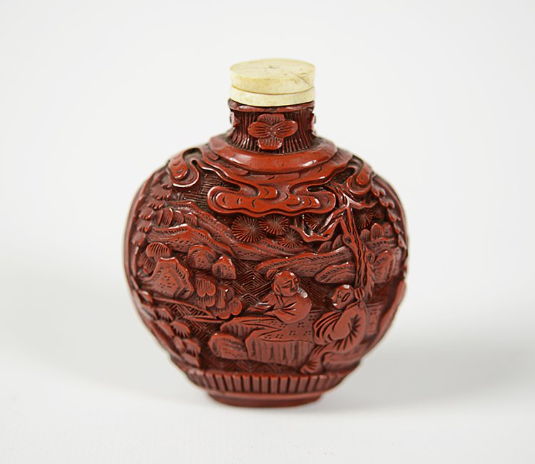 19th Century Chinese Cinnabar Snuff Bottle: 19th Century Cinnabar Snuff Bottle ,with high relief carving of figures in a landscape, with flattened ivory top. Appx. 2 1/4 W, 2 5/8 H.