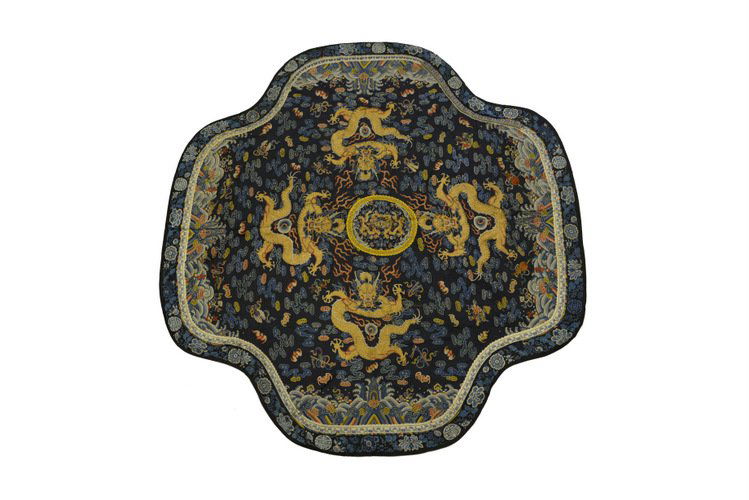 Late Qing Chinese Embroidered Dragon Panel: Late Qing Chinese Embroidered Dragon Panel, of rounded cruciform shape, embroidered in colored silks and couched in gold thread, the center roundel with opposing dragons framed by a yellow floral bord