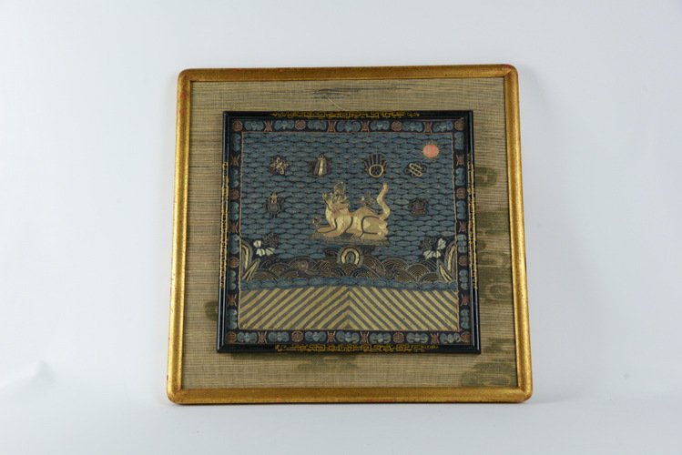Late Qing Chinese Military Badge: Late Qing Chinese Military Badge, couched with gold and silver thread and embroidered with various silks, the second rank badge with a lion surrounded by auspicious emblems and above waves and rocks a