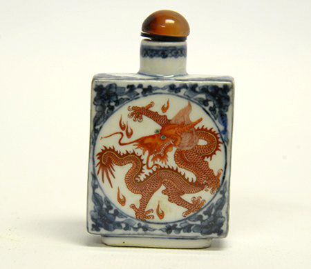 Chinese Porcelain 'Dragon' Snuff Bottle: Chinese Porcelain 'Dragon' Snuff Bottle, of flattened rectangular form, the front and reverse each painted with a copper red five clawed dragon in a central roundel surrounded by a blue and white mean