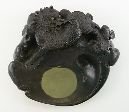 Late 19th/Early 20th C. Chinese Duan Inkstone: Late 19th/Early 20th Century Chinese Duan Inkstone, the inkstone carved in high relief with a qilin amidst clouds above a swirling water reservoir marked at the center by a central green circle in the