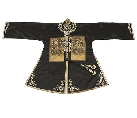 A Chinese Woman's Silk Rank Jacket: A Chinese Woman's Silk Rank Jacket, worn by an officer's wife, the black silk jacket with rank badges couched in gold thread to the front and back and applied flowers embroidered in colored silks, wit