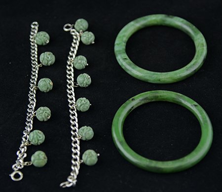 Chinese Jade and Sterling Silver Bracelets: Chinese Jade and Sterling Silver Bracelets, with two circular spinach green jade bangle bracelets, and two sterling silver chain link bracelets with carved jade beads, carrying 13 beads in total, one 