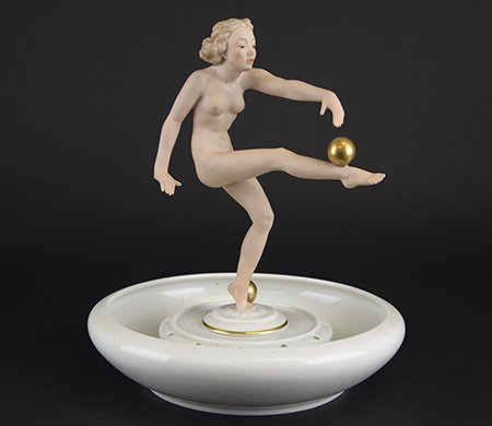 German Porcelain Flower Frog & Figurine: German Porcelain Flower Frog & Figurine, the white glazed flower frog with Art Deco style painted porcelain figurine of a nude woman balancing gilt balls, each with mid 20th century marks for Hutschen