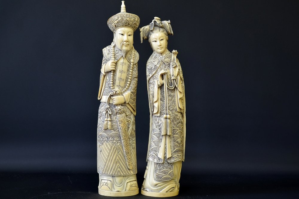 A Pair of 19th C. Chinese Signed Ivory Figures: A Pair of 19th C. Chinese Signed Ivory Figures, including a man and a woman both wearing dragon robes, both signed to base, the tallest appx. 13 in. H.