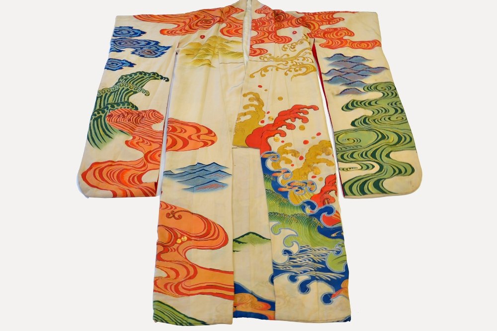 A Japanese Embroidered 'Swinging Sleeves' Kimono: A Japanese Embroidered 'Swinging Sleeves' Kimono, Furisode, the cream colored kimono dyed and couched in metallic threads with stylized wave patterns, with some loose threads particularly at the shoul