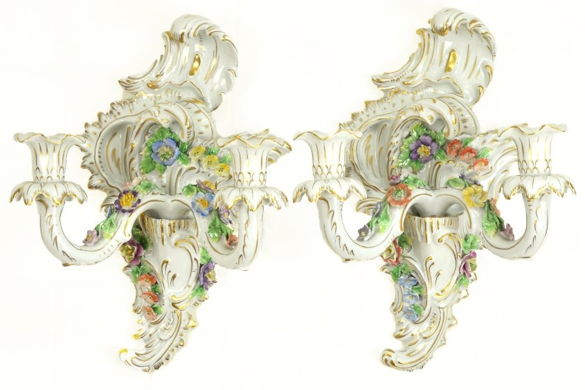 A Pair of Dresden Porcelain Wall Sconces: A Pair of Dresden Porcelain Wall Sconces, the rococo style sconces with relief carved floral decoration, with chips and some damage to flowers, appx. 13 in. H.