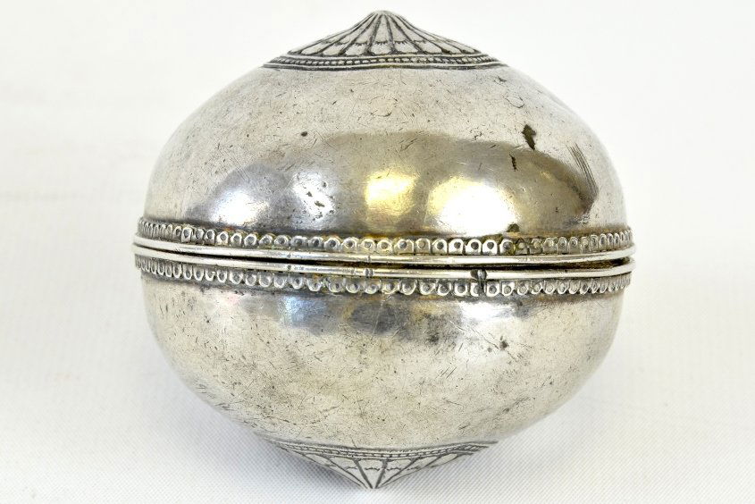 A Middle Eastern Antique Silver Hand Warmer: A Middle Eastern Antique Silver Hand Warmer, 18th century or possibly earlier, the round hand warmer with beaded borders and carved medallions to each side, appx. 2 5/8 in. DIA.
