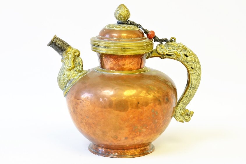 A Middle Eastern Copper, Brass and Silver Teapot: A Middle Eastern Copper, Brass and Silver Teapot, the copper tea pot with brass dragon handle and brass animal spout with silver wrapped mouth, with dents, appx. 8 1/4 in. H.