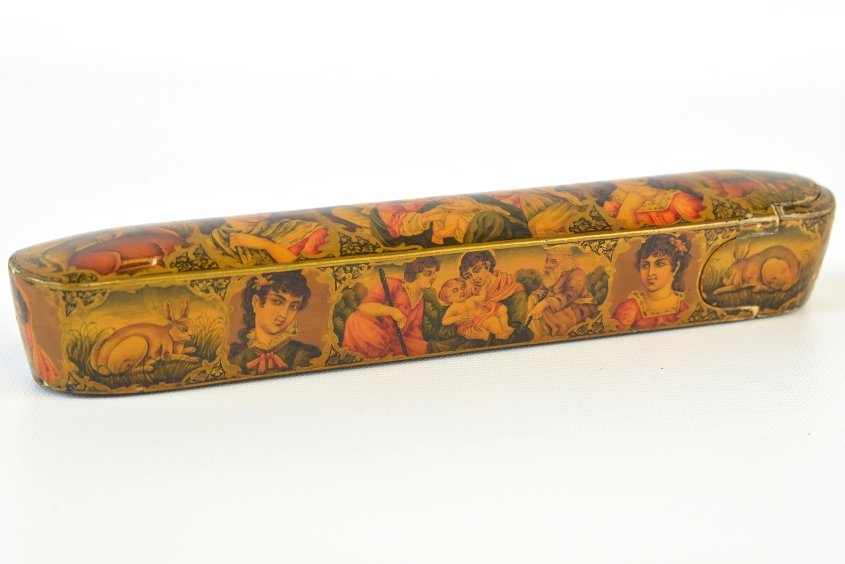 A Qajar Lacquered Papier-Mache Pencase: A Qajar Lacquered Papier-Mache Pencase, of typical elongated form, with medallions containing religious scenes to the top and sides, with wear and damage to surface, appx. 8 7/8 in. W.