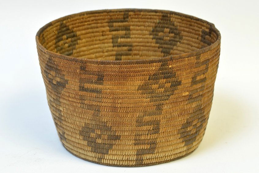 A Native American Apache Basket: A Native American Apache Basket, woven willow cylindrical basket with designs, appx. 5 in. H, 8 in. DIA.