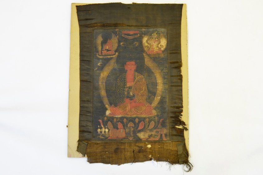 18th Century Tibetan Thangka Painting: 18th Century Tibetan Thangka Painting, with central image of Buddha on a lotus throne flanked by two smaller Buddha at the top corners, appx. 26 1/2 in. H.