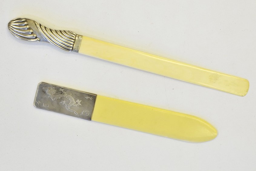 A Pair of 19th Century Silver & Ivory Page Turners: A Pair of 19th Century Silver & Ivory Page Turners, one with rectangular handle carved with a dragon to each side, the other with shaped gadrooned handle with London sterling marks dated 1902, the lon