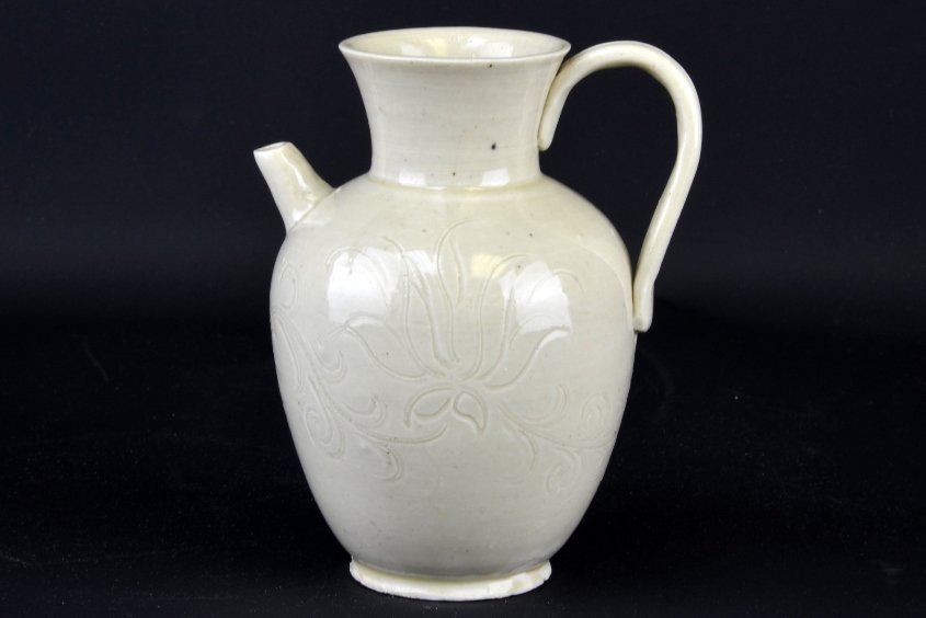 A Chinese Ding Ware Pitcher: A Chinese Ding Ware Pitcher, the pitcher incised with flowers, appx. 5 3/4 in. H._x000D_ _x000D_ Provenance: From the Estate of Patrick H. Booth, Jr.