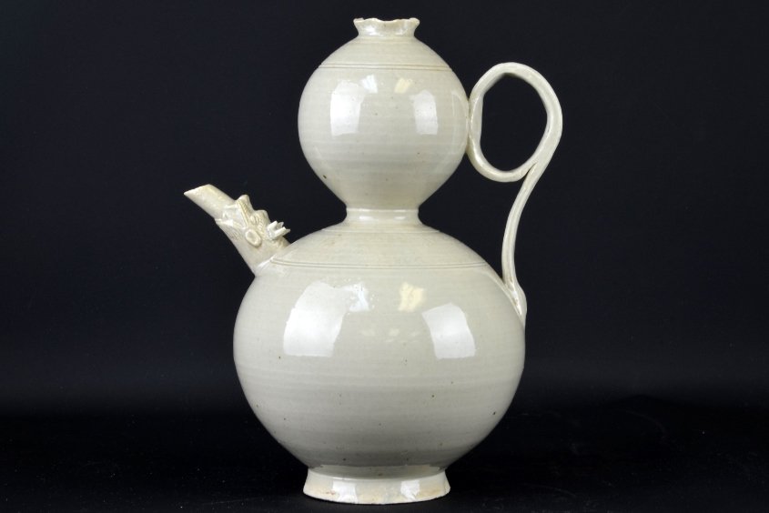 A Chinese Ding Ware Double Gourd Pitcher: A Chinese Ding Ware Double Gourd Pitcher, the spout carved with a dragon head, appx. 9 1/8 in. H._x000D_ _x000D_ Provenance: From the Estate of Patrick H. Booth, Jr.