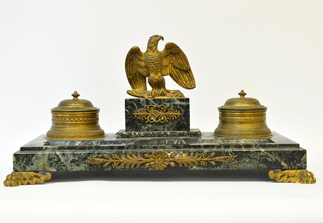 A French Marble and Bronze Inkwell: A French Marble and Bronze Inkwell, likely 19th century, the Louis XV style double inkwell with bronze eagle and inkpots, with chips to top, appx. 14 3/4 in. W. 7 3/4 in. D.