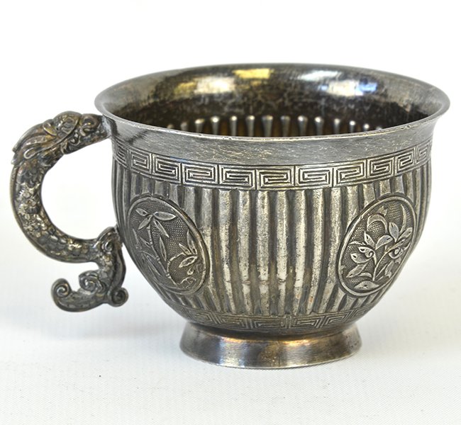 A 19th/20th C. Chinese Silver Teacup: A 19th/20th C. Chinese Silver Teacup, the cup decorated in repousse to show panels containing bamboo and prunus flowers within a reeded ground, mounted with a dragon handle, with marks to the base, ap