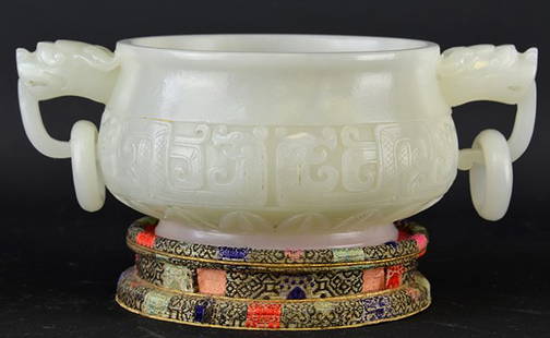 A Chinese Jade Censer: A Chinese Jade Censer, of compressed globular form, mounted with foo dog heads suspending loose rings, the body carved with archaic decoration, appx. 6 1/4 in. W.