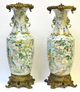 A Pair of 19th Century Chinese Baluster Vases: A Pair of 19th Century Chinese Baluster Vases, the vases enameled with figures in Chinese landscapes and mounted with pairs of Chi Dragons and Cranes to the neck and shoulder, fitted with European mou