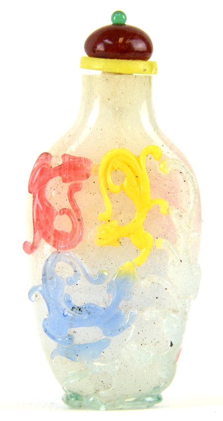An 18th Century Chinese Peking Glass Snuff Bottle: An 18th Century Chinese Peking Glass Snuff Bottle, carved through five color overlay to a bubble suffused ground with chi dragons, the foot ring in the form of a sinuous dragon encircling the base, ap