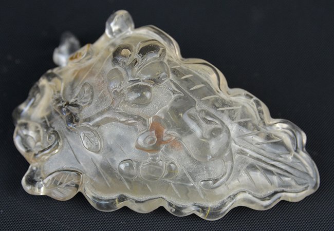 A Chinese Crystal Snuff Bottle: A Chinese Crystal Snuff Bottle, in the form of a leaf carved to the top with a squirrel amidst flowering prunus branches, appx. 3 18 in. W.