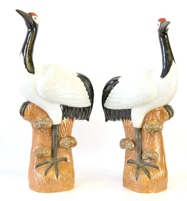 A Pair of Japanese Porcelain Cranes: A Pair of Japanese Porcelain Cranes, modeled as cranes resting on tree trunks, the tallest appx. 20 1/4 in. H.