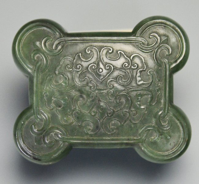 A Chinese Spinach Jade Box, Qing Dynasty: A Chinese Spinach Jade Box, Qing Dynasty, Qianlong period, lobed with stylized double bat motif on lid, part of a three piece garniture, similar example in the National Palace Museum, appx. 2 in. H, 2