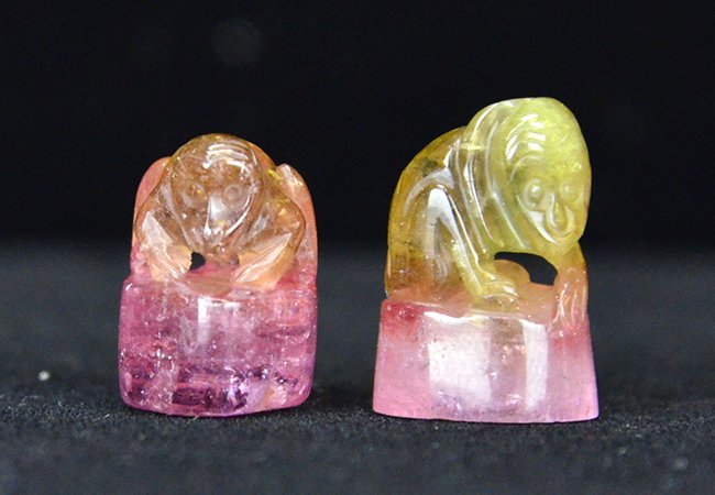 A Pair of Miniature Chinese Tourmaline Carvings: A Pair of Miniature Chinese Tourmaline Carvings, the pink and green tourmaline pebbles each carved in the form of a monkey on a boulder, appx. 5/8 in. H.