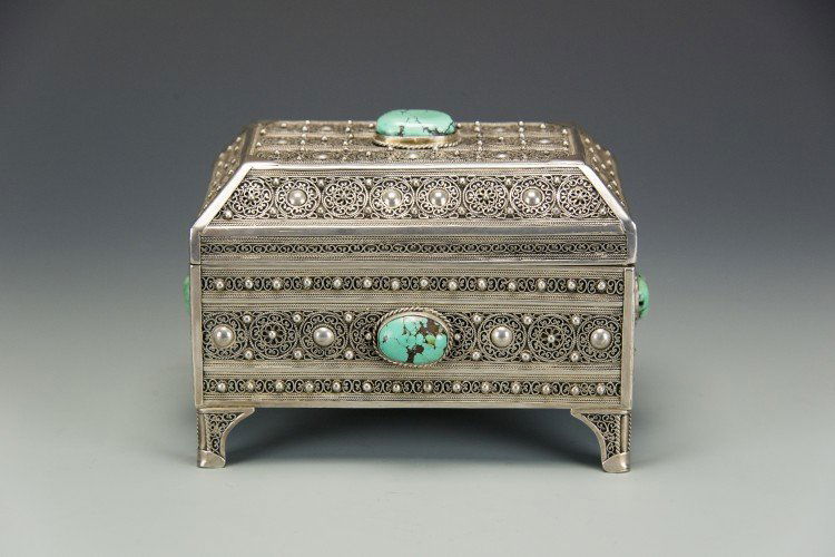 A 19th Century Silver Etrog Box with Turquoise: A 19th Century Silver Etrog Box with Turquoise, with a hinged lid and four legs, intricately decorated with Yemenite filigree and inset turquoise stones, signed in Hebrew on the inner front lip, appro
