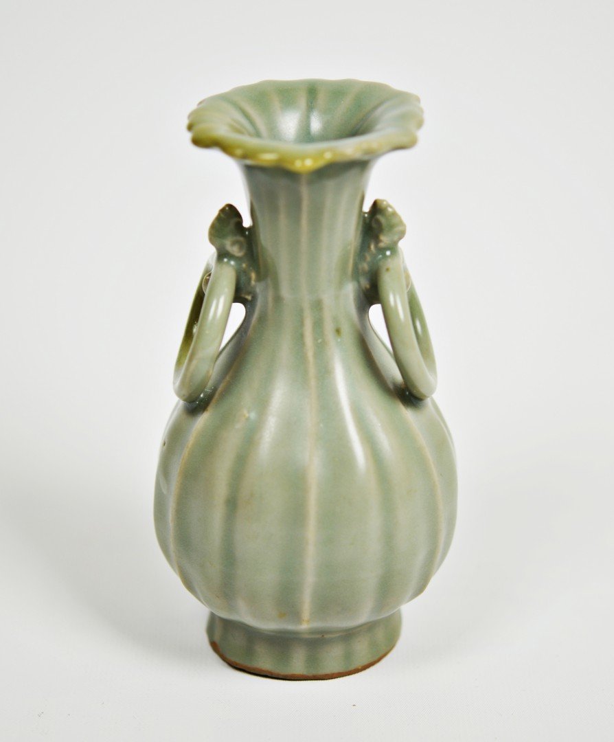 A Fine Song Dynasty Longquan Celadon Amphora: Song dynasty (960-1279). The amphora a with a foliate shaped mouth rim above a cylindrical neck with applied ring handles, the ribbed pear-shaped body raised on flared foot, the buff-colored porcelain
