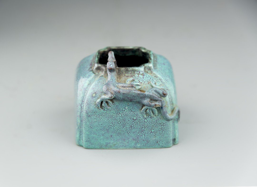 A Chinese Porcelain Lujun Brush Washer: 19th century, Qing dynasty. The squared porcelain brush washer with canted corners and a short straight rim, an applied dragon stretching from the shoulder to rim, covered in a spotted robinâ€™s 